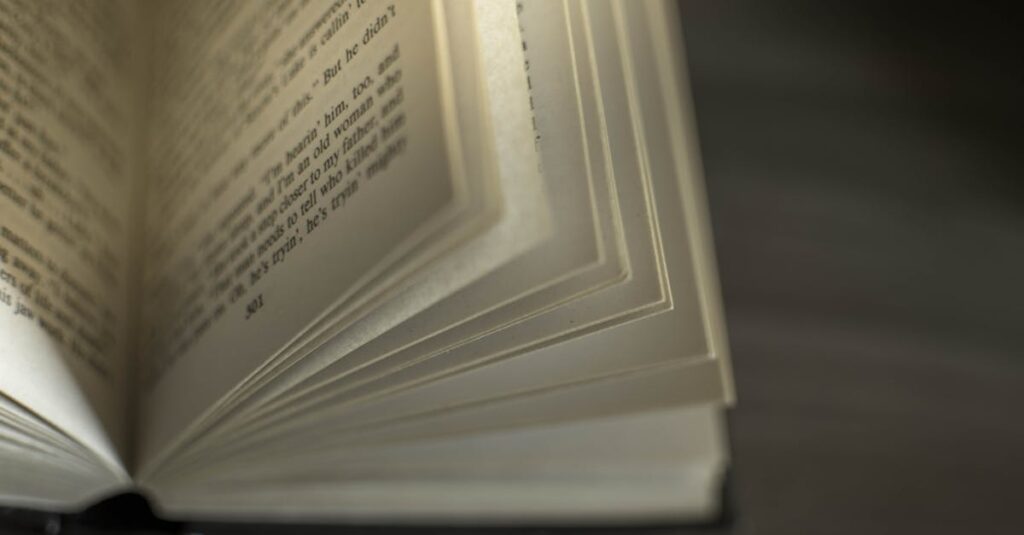 A close-up image of an open book with visible text, showcasing turning pages.